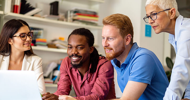 Marketing team looking at computer