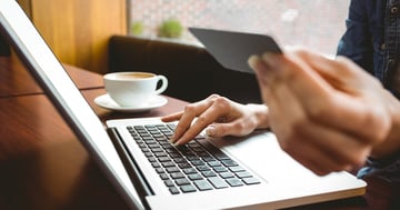 Person using a laptop to pay for a business website