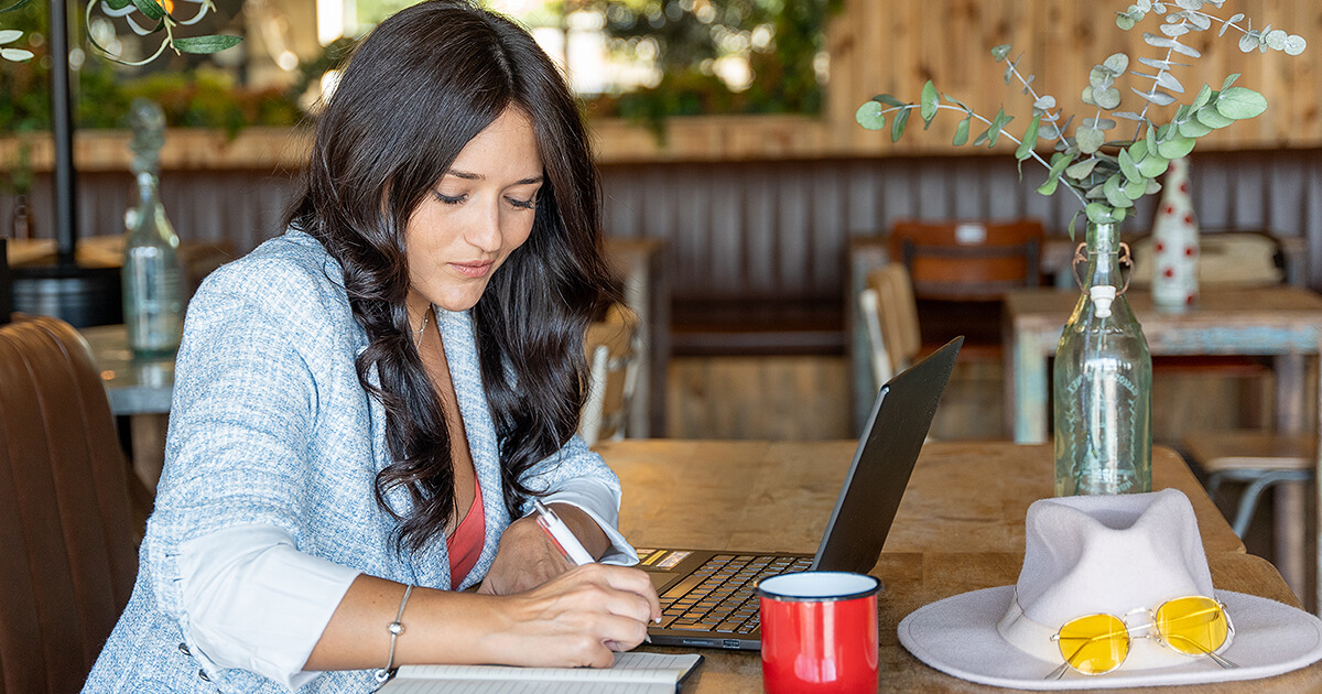 women using computer at a restaurant planning business