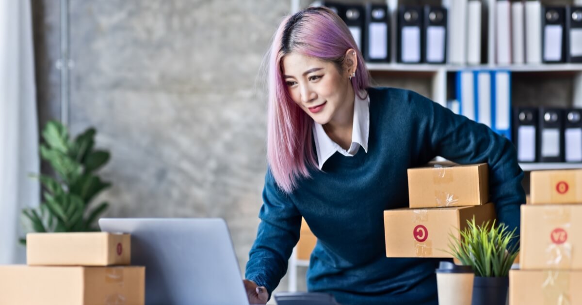 Women with packagings doing something on the computer